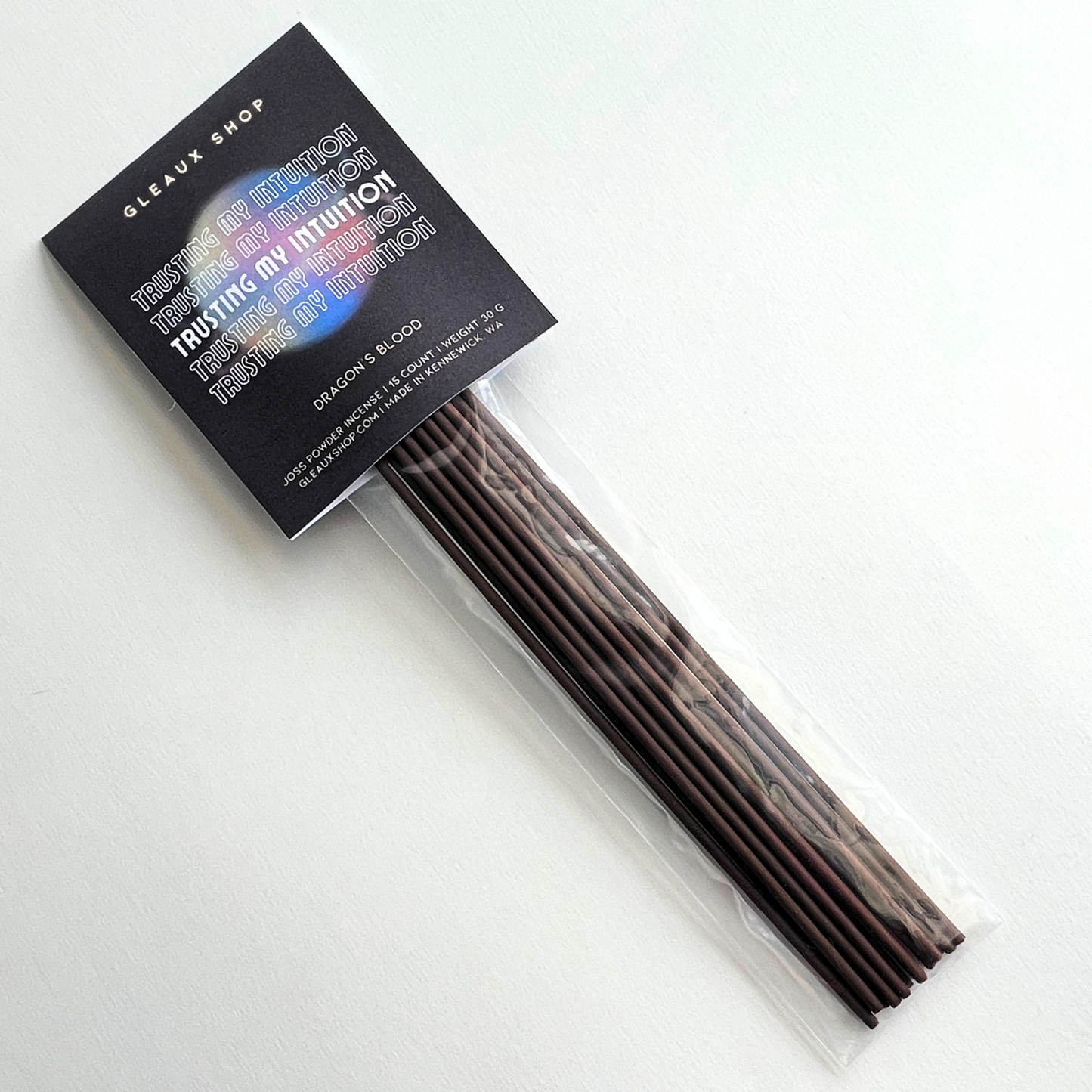 A pack of Dragon’s Blood incense sticks by Gleaux Shop with the product label 'TRUSTING MY INTUITION' displayed on top.